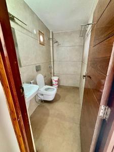 a small bathroom with a toilet and a sink at Hotel Channo Residency in Nadāmpur