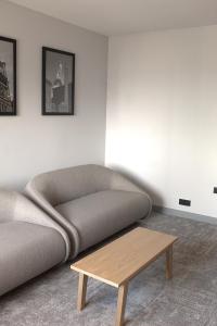 a living room with a couch and a coffee table at Radisson Blu Hotel, Liverpool in Liverpool +88 photos
