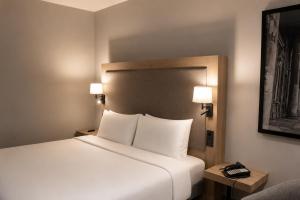 a bedroom with a bed with two lamps and a phone at Radisson Blu Hotel, Liverpool in Liverpool