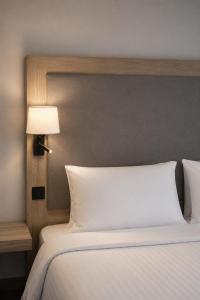 a bedroom with a white bed with a lamp on it at Radisson Blu Hotel, Liverpool in Liverpool