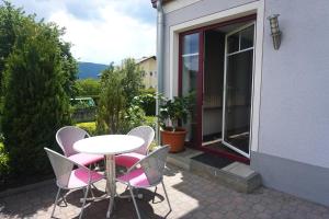 a table and chairs on a patio with a window at Ferienwohnung Heidi in Mariapfarr