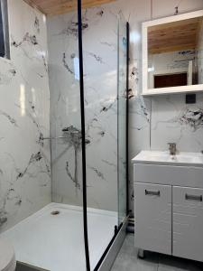 a bathroom with a shower and a sink at Bayaman Guest House in Bokonbayevo +19 photos