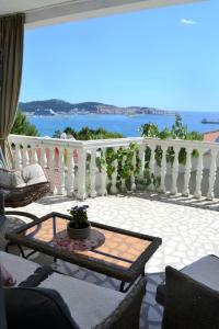 a balcony with a white railing and a table at Holiday house Ogi in Bar
