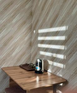 a toaster sitting on top of a wooden table at Bayaman Guest House in Bokonbayevo