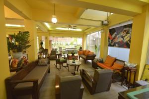a living room with couches and a table at Sourire at Rattanakosin Island Hotel in Bangkok