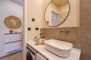 a bathroom with a sink and a mirror at Apartment Na broju3 in Krk +10 photos