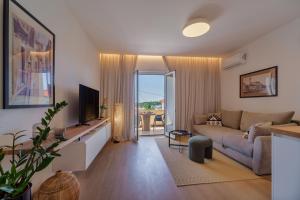 a living room with a couch and a television at Apartment Na broju3 in Krk