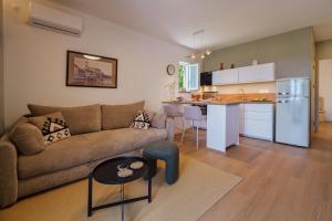 a living room with a couch and a kitchen at Apartment Na broju3 in Krk