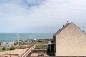a building with a view of the ocean at Carley's House - Macduff Seaside Escape in Macduff