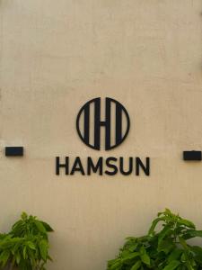 a sign for the hdi hammin company on a wall at Hamsun Shahrah-e-Faisal Extension in Karachi