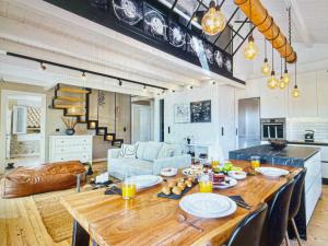 a kitchen and living room with a large wooden table at Amazing apartment with view in Kanoni +17 photos