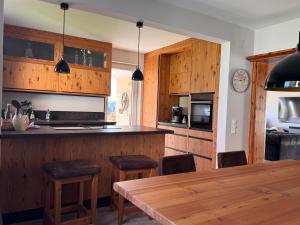 a kitchen with wooden cabinets and a wooden table at Haus König in Kirchbach