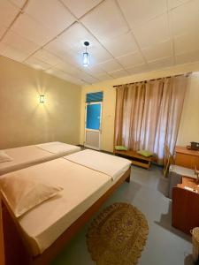 a large bedroom with two beds and a window at Wilpattu Wildhideaway Lodge in Galkadawala