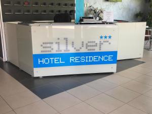 a reception desk with a hotel reference sign on it at Silver Residence Hotel in Bagnolo in Piano