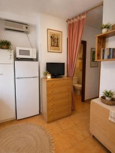 a kitchen with a white refrigerator and a microwave at Mabre view in La Mata