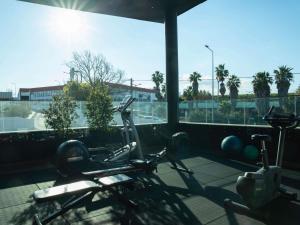 a gym with two exercise bikes and a window at ibis Styles Lisboa Aeroporto in Lisbon