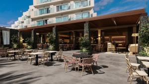 a patio with tables and chairs in front of a building at HD Sensarena - Adults Only in Costa Teguise