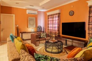 a living room with a large flat screen tv at Luxe Oasis Palma in Quatre Bornes