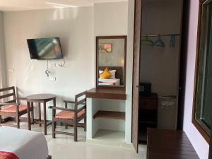 a room with a table and chairs and a mirror at Smile Home in Patong Beach