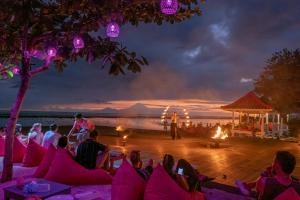 a group of people sitting on the beach watching a performance at PinkCoco Gili Trawangan - Constant Surprises - for Cool Adults Only in Gili Trawangan +94 photos