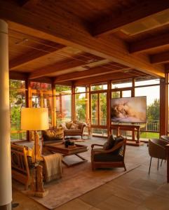 a living room filled with furniture and a large screen at Alpine Sunlight Villa in Villach