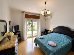 a bedroom with a bed and a television and a window at Casa Machado in Vila Real