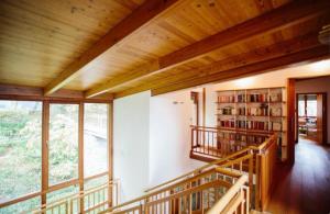 a room with a staircase and a book shelf at Alpine Sunlight Villa in Villach