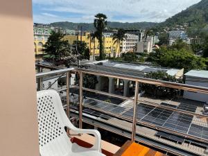 a balcony with two chairs and a view of a city at Smile Home in Patong Beach