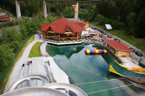 an amusement park with a large building in the water at Thalerhof-Markus in Roppen