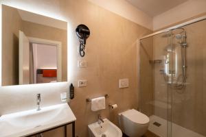 a bathroom with a toilet and a sink and a shower at Hotel Sangallo in Monte San Savino +22 photos