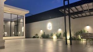 a patio of a house at night with lights at شاليه اغصان الباحة in Al Baha +8 photos