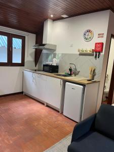 a kitchen with a sink and a counter top at Bungalow Refúgio do Pezo T0 in Melgaço