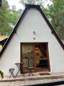 a small white house with a large window at Bungalow Refúgio do Pezo T0 in Melgaço