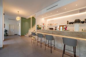 a bar with a row of stools at Hotel Sangallo in Monte San Savino