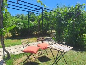 a picnic table and two benches in a yard at Rosales Collection Vacation Villa in Medina de Pomar