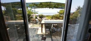 a view of a patio with a table and chairs at Apartment Tušek in Jadranovo