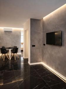 a dining room with a table and a television on a wall at LEMIGA SUiTE VALENCIA in Valencia
