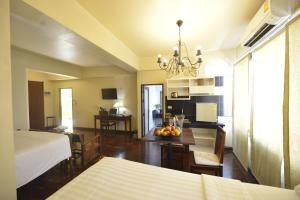 a room with a bed and a table with fruit on it at Sourire at Rattanakosin Island Hotel in Bangkok