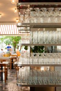 a bunch of glasses on a shelf in a restaurant at Hotel Daniel Graz - Smart Lifestyle Near City Centre in Graz +46 photos