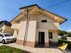 a house with a car parked in front of it at Apartment Alee in Lesce