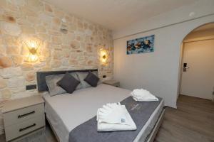 a bedroom with a bed and a stone wall at Nova Prime in Bodrum City