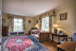 a living room with a couch and a rug at Timberley House by Group Retreats in Pulborough +73 photos