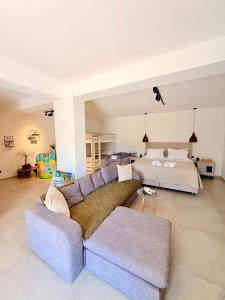 a living room with a couch and a bed at Apademia Comfort Studio 65sqm in Skiros