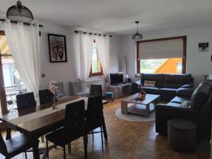 a living room with a couch and a table at "Parenthèse Alsacienne" in Luttenbach-près-Munster