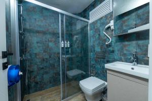 a bathroom with a shower and a toilet and a sink at Nova Prime in Bodrum City