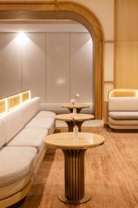 a living room with a couch and a table at Amora Hotel Adelaide in Adelaide