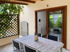 a table with a blue and white table cloth on a patio at Appartamento del Pellicano in Olbia