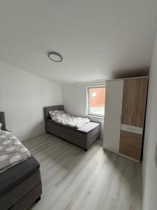 a small bedroom with a bed and a window at Deluxe Apartment II in Velpke