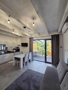 a kitchen and living room with a table and chairs at M&M House in Okuninka