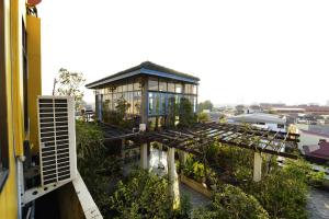 a building with a greenhouse on top of it at Sourire at Rattanakosin Island Hotel in Bangkok